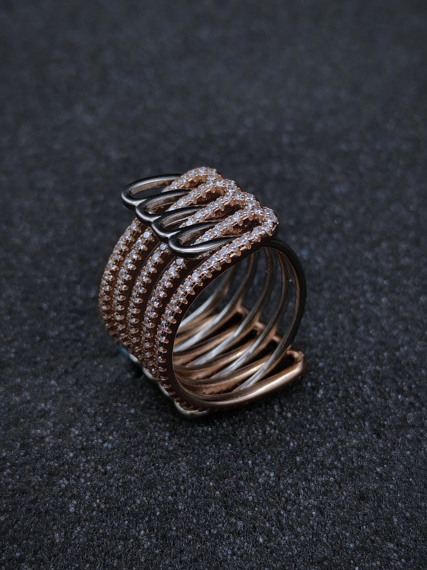 Dual-tone adjustable ring adorned with sparkling Swarovski zircons — elegant five-line design.