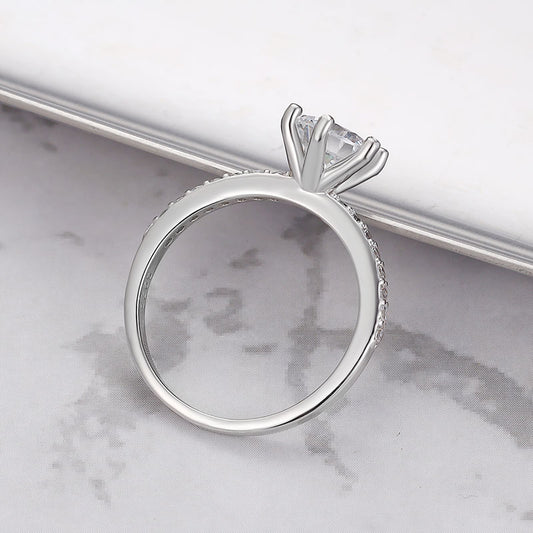 Close-up of sterling silver ring featuring a single sparkling zircon.