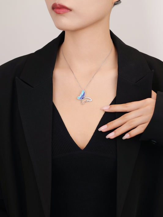Elegant silver chain featuring enamel butterfly pendant.