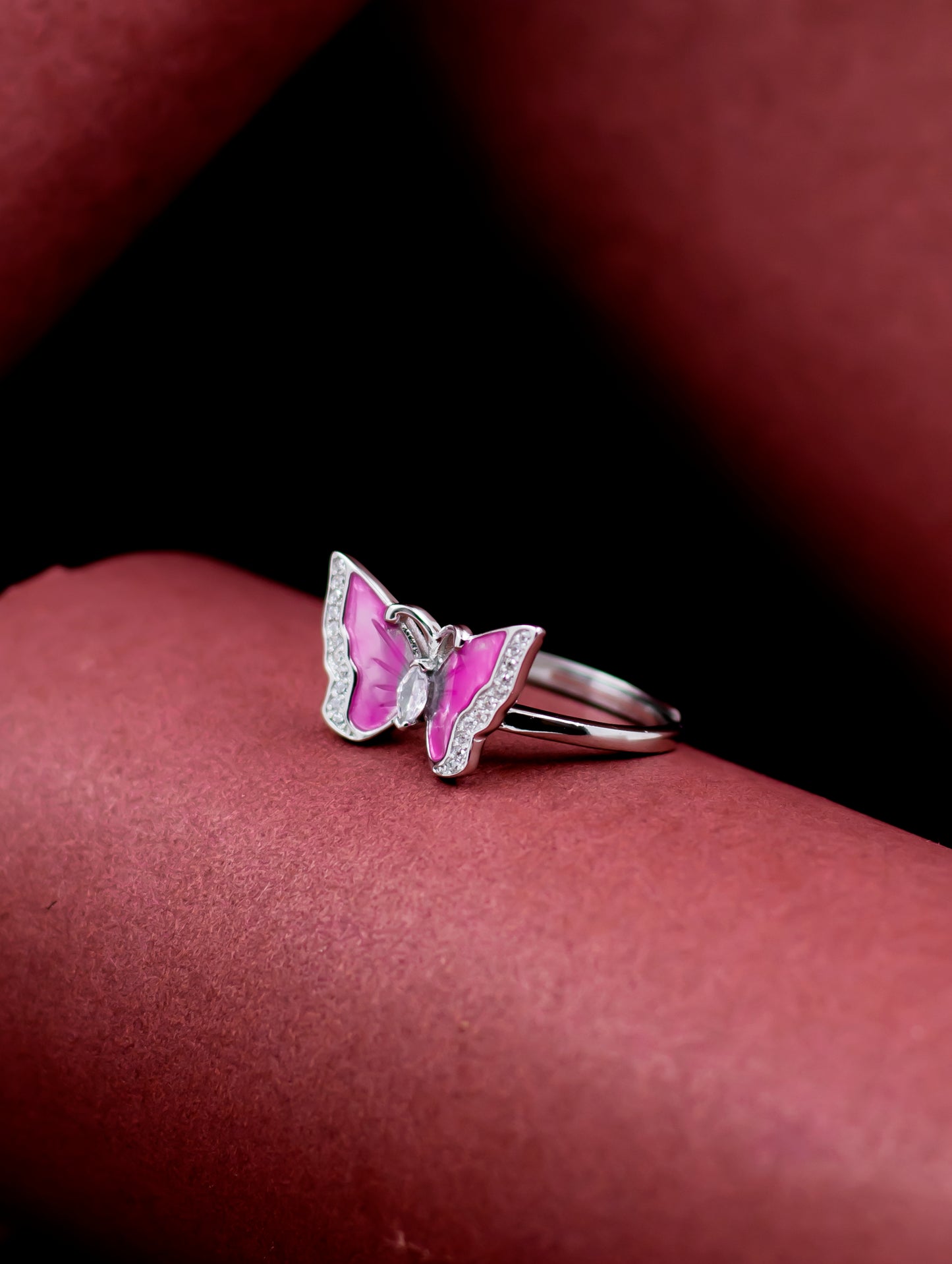 Sterling silver adjustable butterfly ring with pink enamel wings and Swarovski zircons.