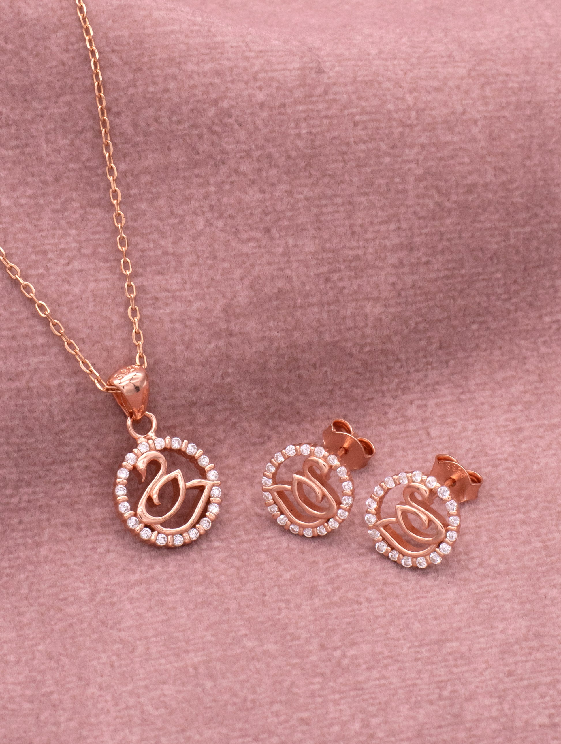 Rose gold swan pendant with zircon stones and matching chain — elegant and luxurious jewelry piece.