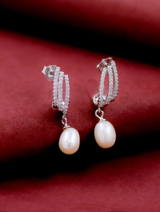 Sterling silver pearl drop earrings with white Swarovski zircon accents.