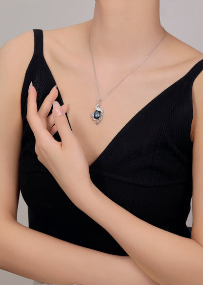 Silver pendant chain adorned with Swarovski zircon and blue gemstone.