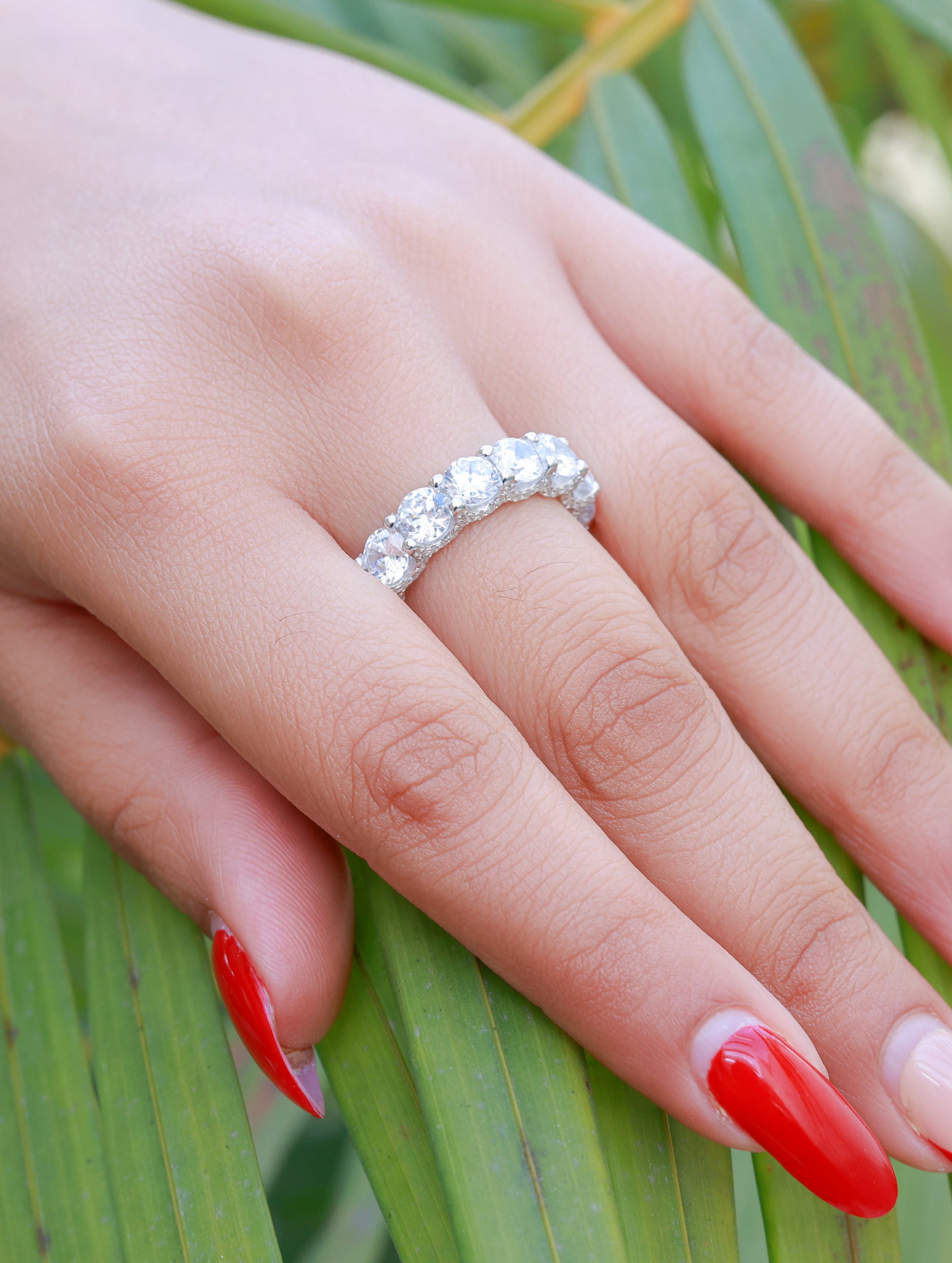 Close-up of silver ring featuring sparkling white Swarovski zircon centerpiece.
