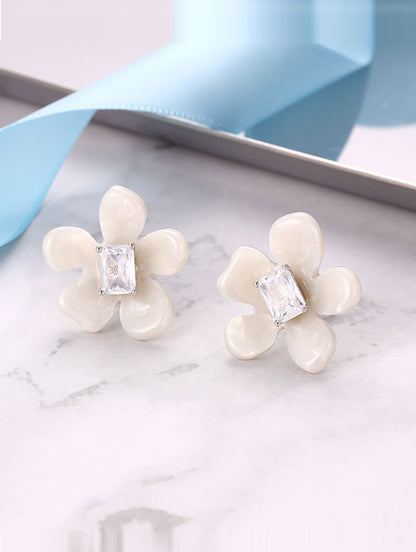 Sterling silver flower-shaped earrings with semi-precious white stones.
