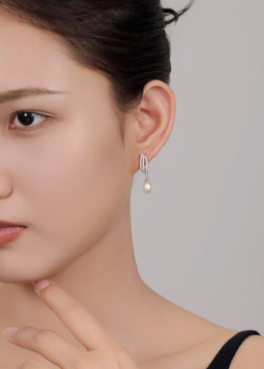 Classic and modern sterling silver pearl drop earrings for women.