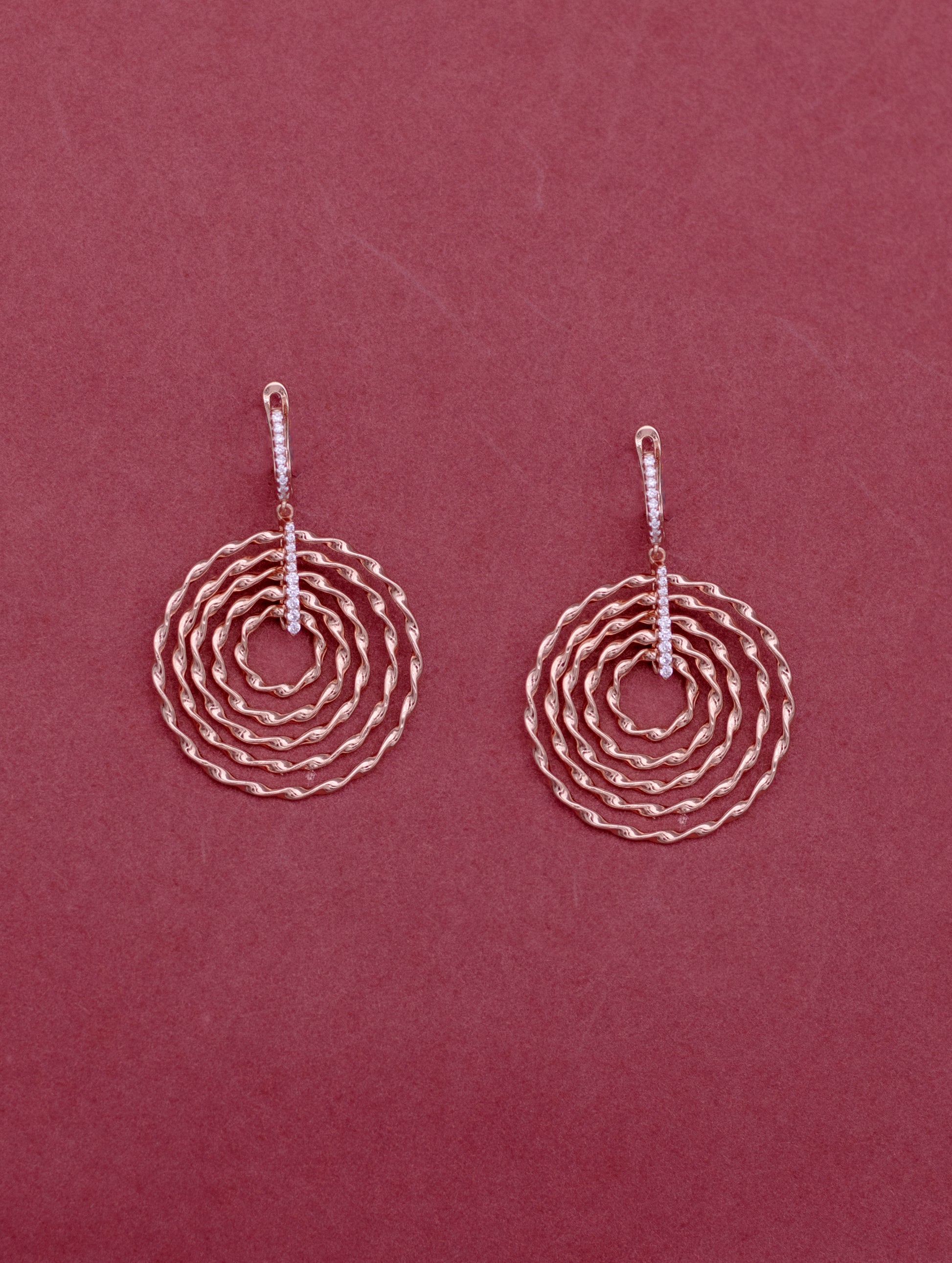 Sterling silver hoop earrings with rose gold plating and white Swarovski zircon.