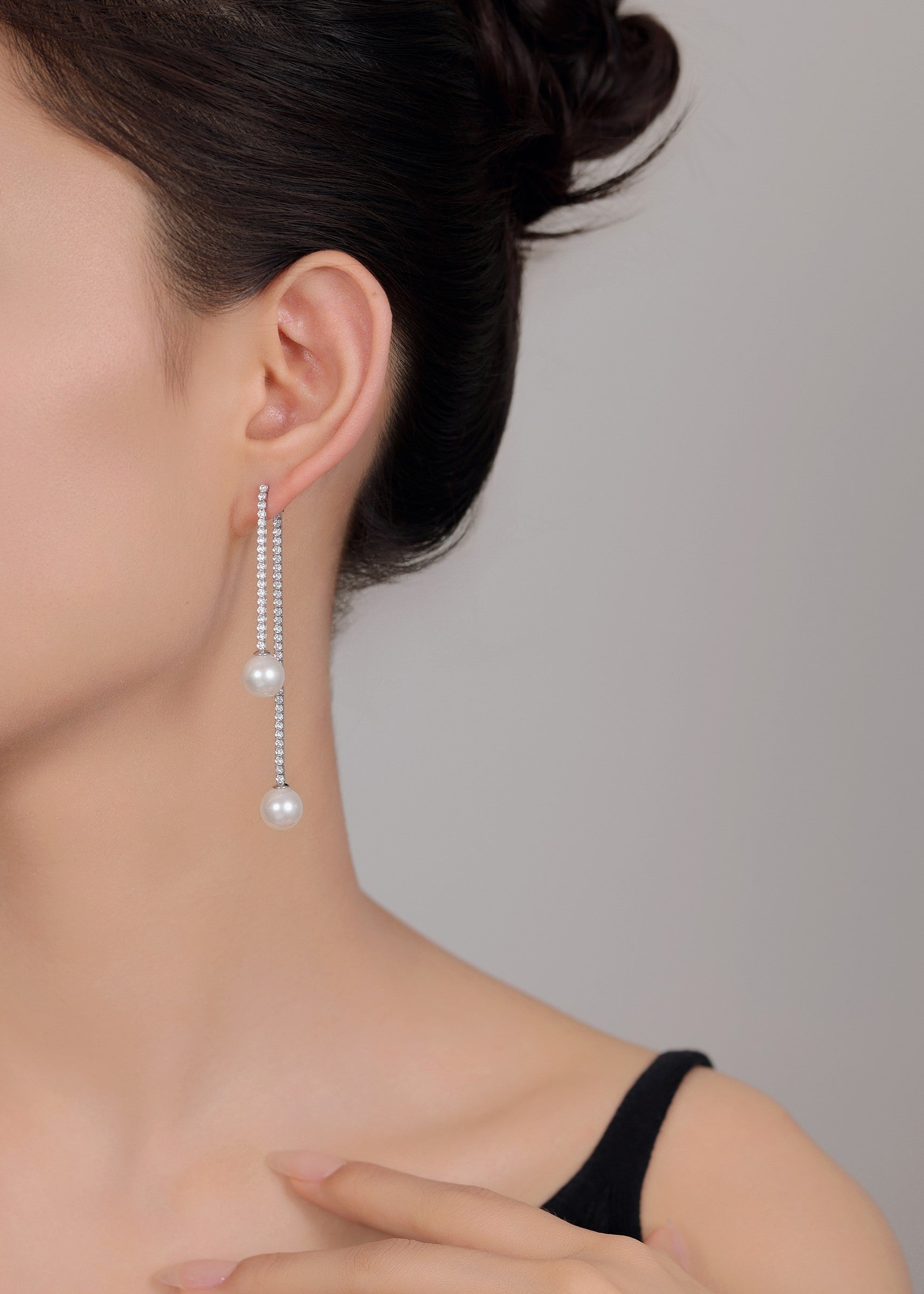 Elegant long earrings featuring natural pearl and silver sparkle.