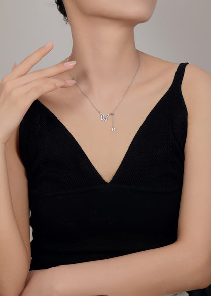 Delicate silver butterfly necklace symbolizing transformation and grace.
