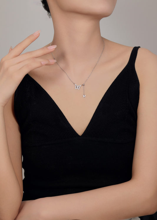 Delicate silver butterfly necklace symbolizing transformation and grace.