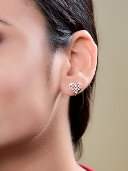 Heart pendant in rose gold symbolizing love and affection, paired with matching earrings.