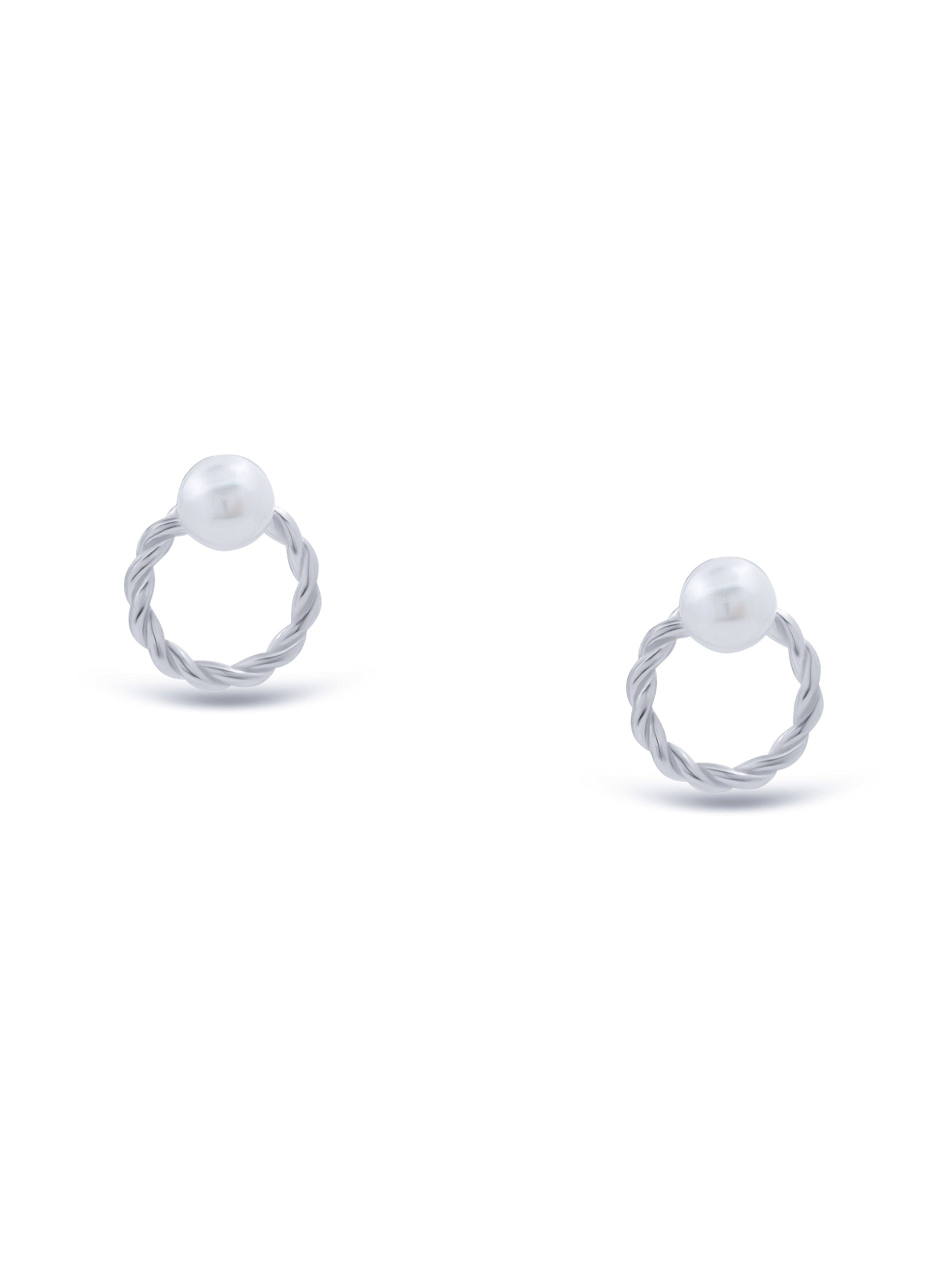 Close-up of sterling silver round-shaped stud earrings with pearl centerpiece.