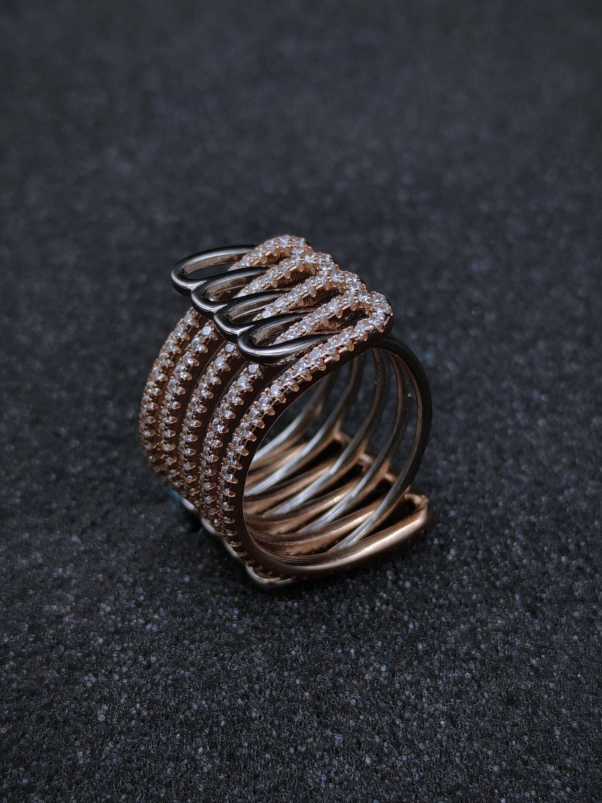 Dual-tone adjustable ring adorned with sparkling Swarovski zircons — elegant five-line design.