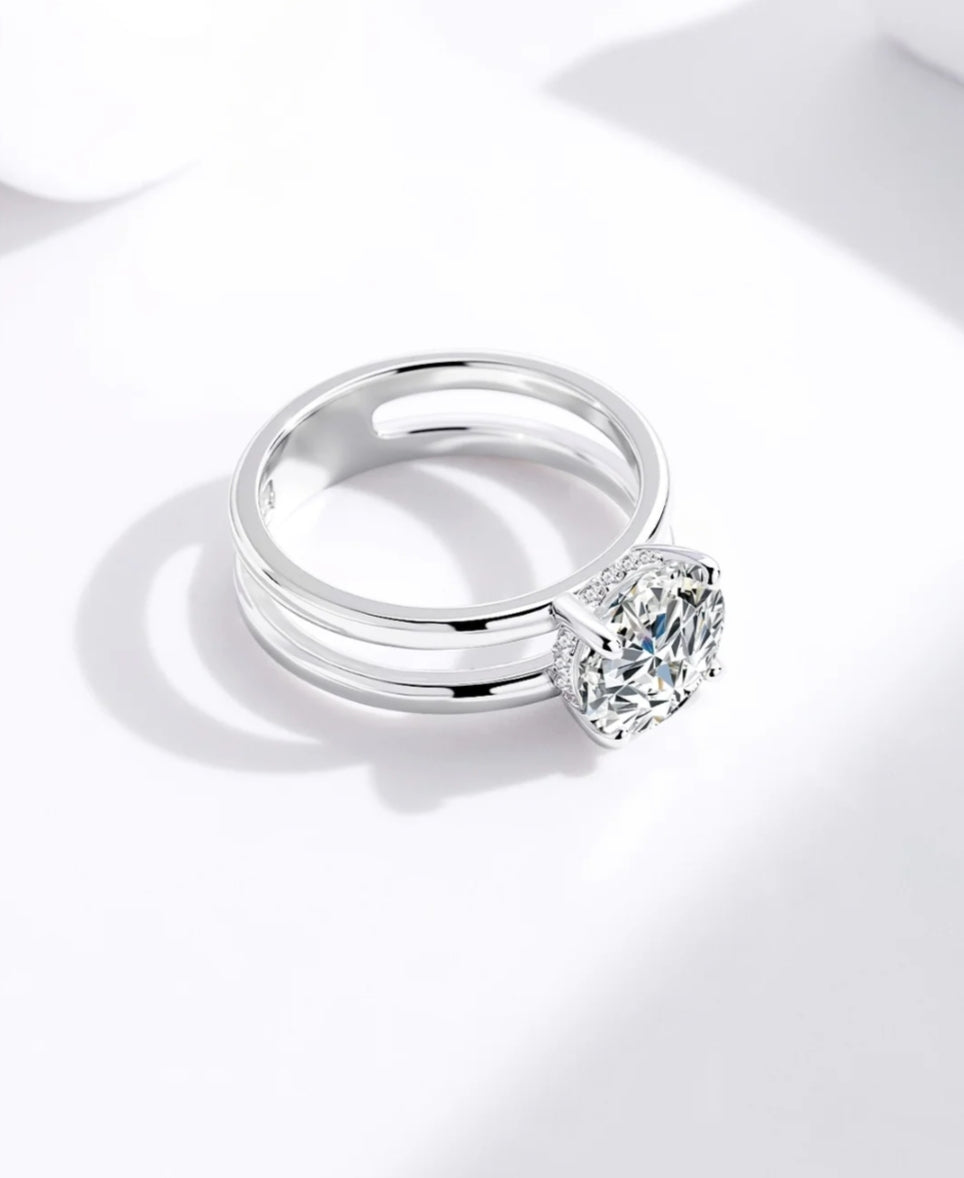 “Handcrafted pure silver ring featuring a radiant solitaire stone and sleek architectural frame.”