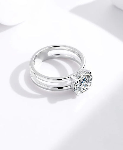 “Handcrafted pure silver ring featuring a radiant solitaire stone and sleek architectural frame.”