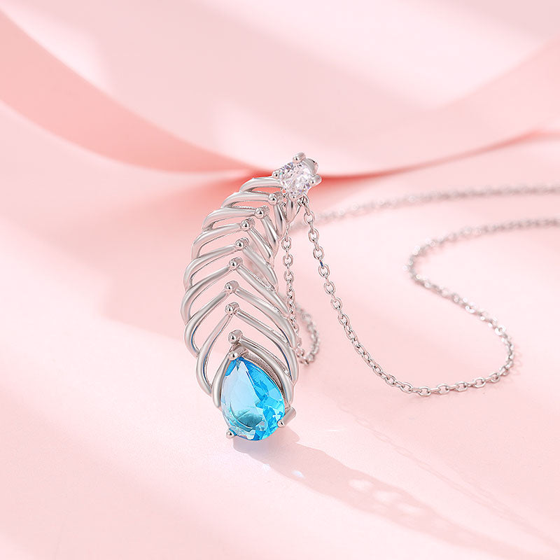 Silver chain with peacock feather pendant featuring blue and white stones