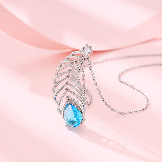 Silver chain with peacock feather pendant featuring blue and white stones