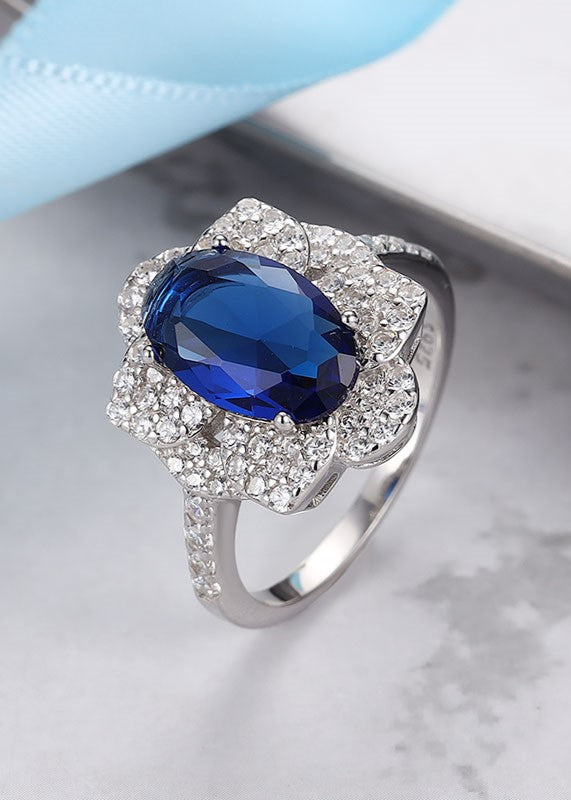 Sterling silver ring with blue stone and white Swarovski zircon — elegant design.