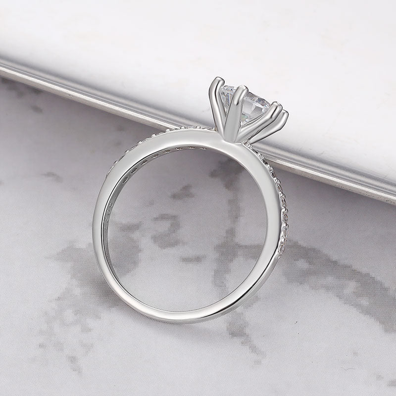 Close-up of sterling silver ring featuring a single sparkling zircon.