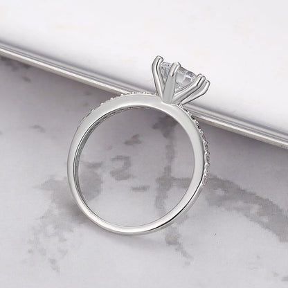 Close-up of sterling silver ring featuring a single sparkling zircon.