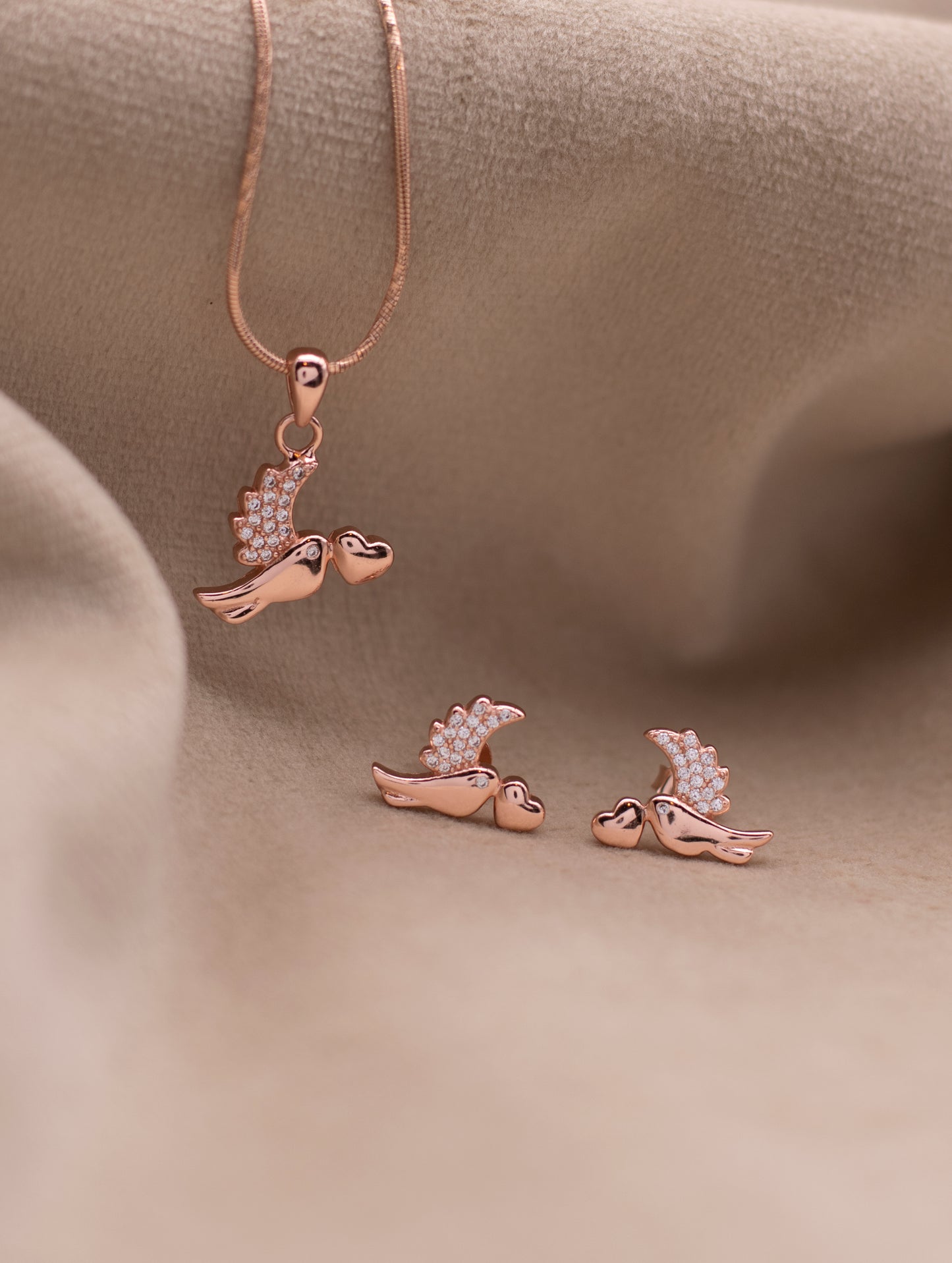 “Elegant nature-inspired bird necklace in rose gold finish”