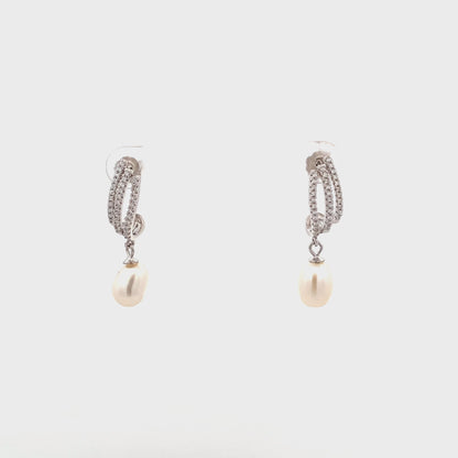 Elegant silver earrings featuring natural pearl drops and sparkling zircon.
