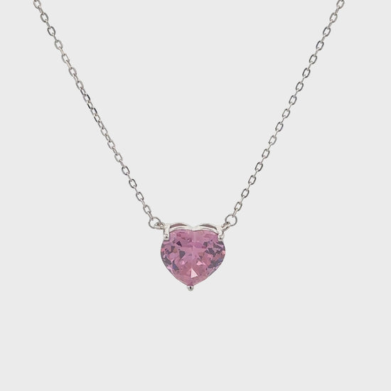 Elegant silver necklace featuring a pink heart-shaped stone.