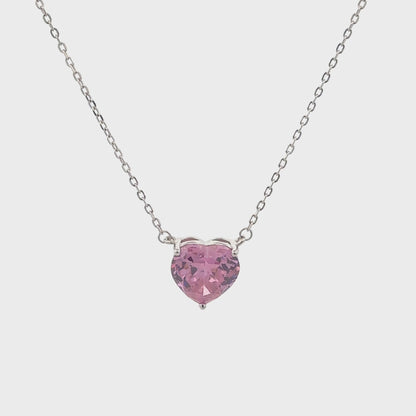 Elegant silver necklace featuring a pink heart-shaped stone.