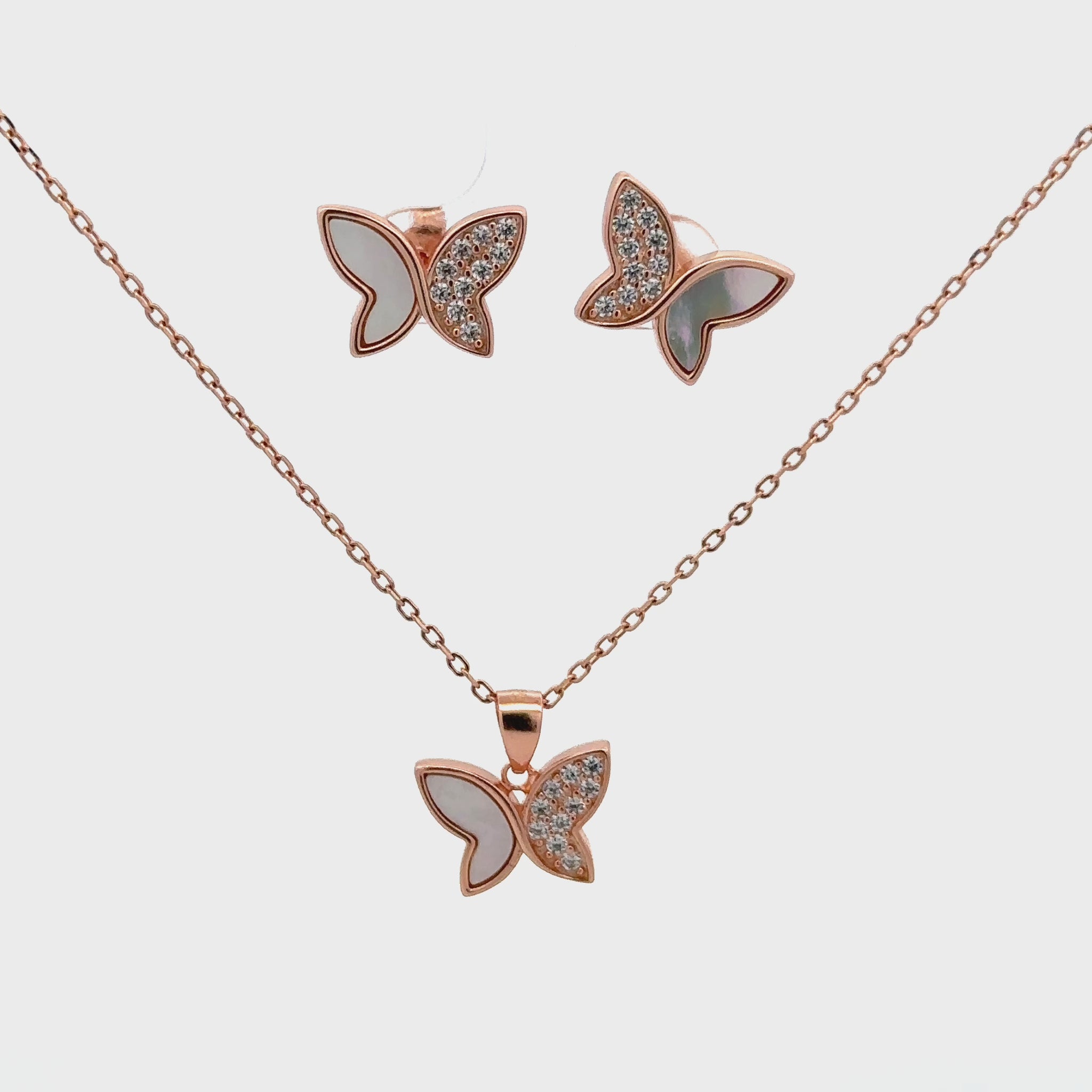 Elegant rose gold butterfly pendant set combining Swarovski sparkle with the natural glow of mother of pearl.