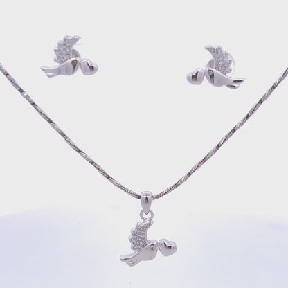 Bird pendant and matching earrings set in sterling silver featuring white Swarovski crystals and heart motif — symbolic and graceful.