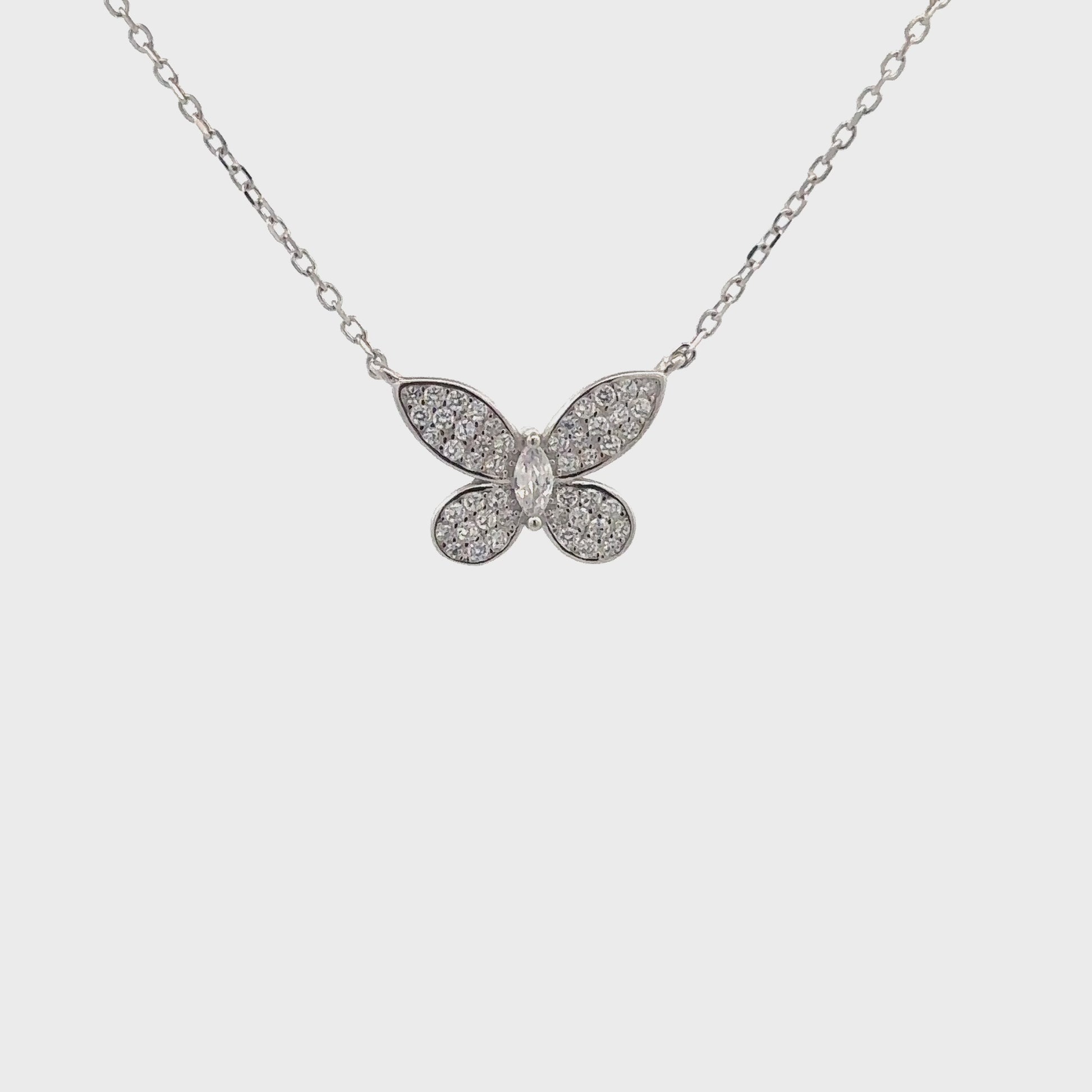 Delicate silver butterfly pendant symbolizing transformation and grace.