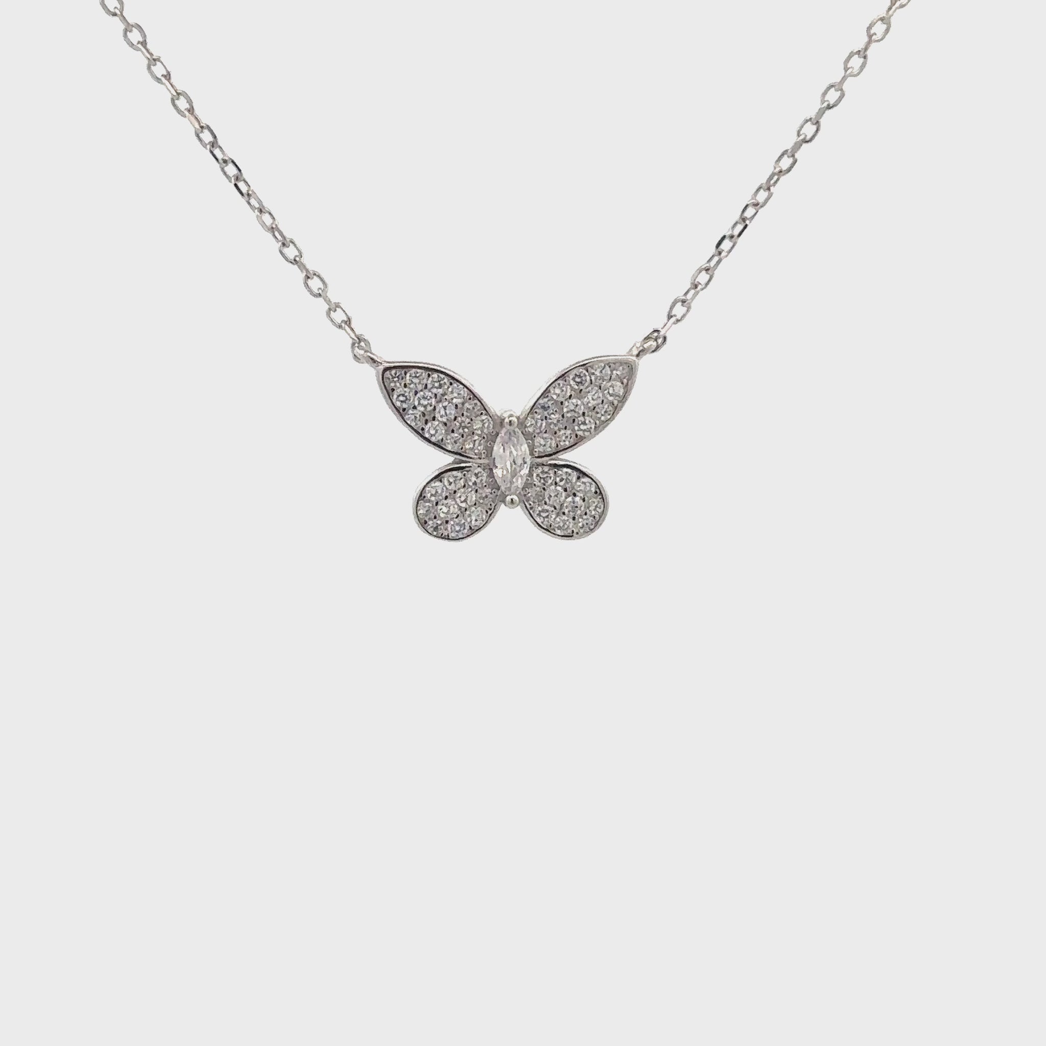 Delicate silver butterfly pendant symbolizing transformation and grace.