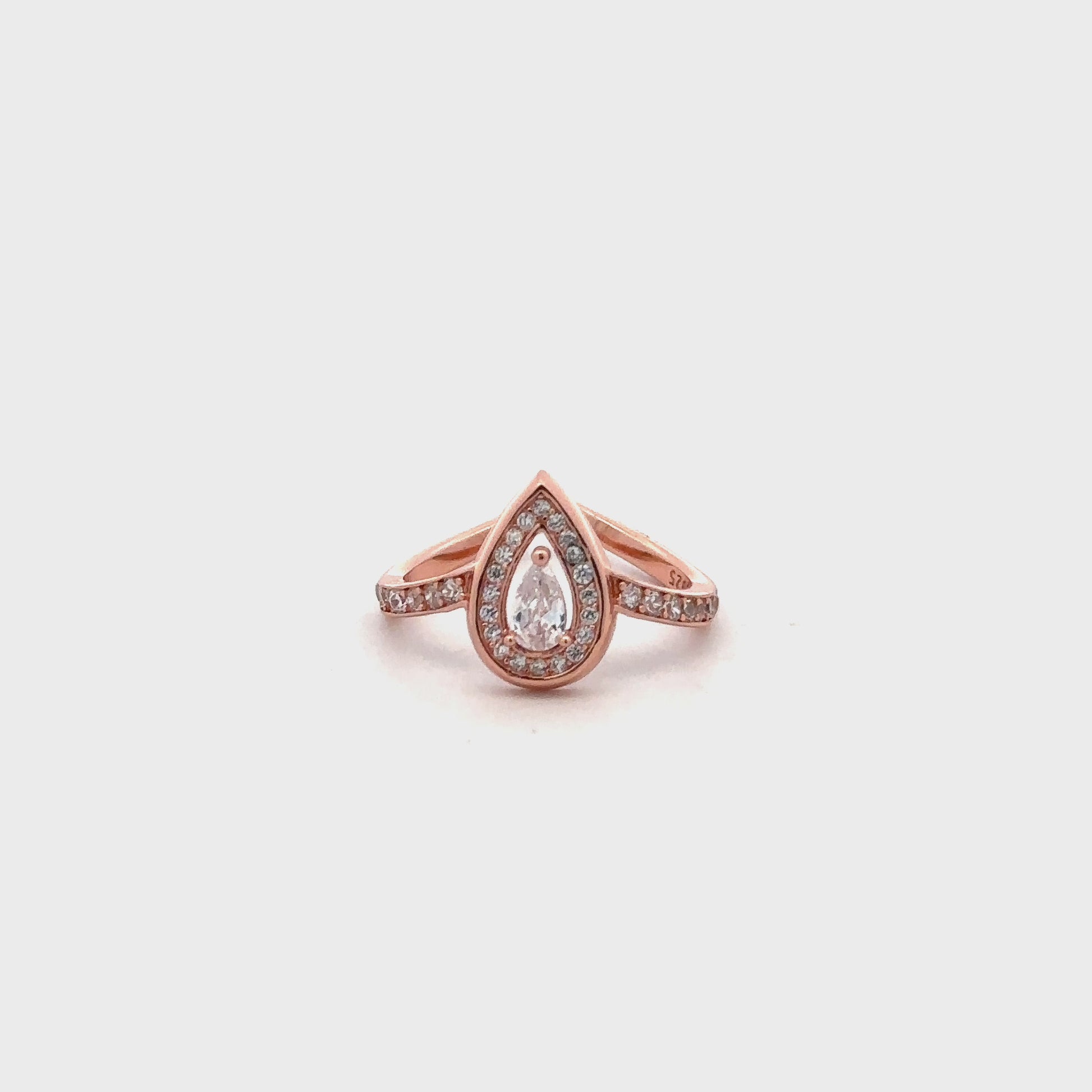 Close-up of rose gold ring featuring solitaire Swarovski zircon in a drop-shaped setting.