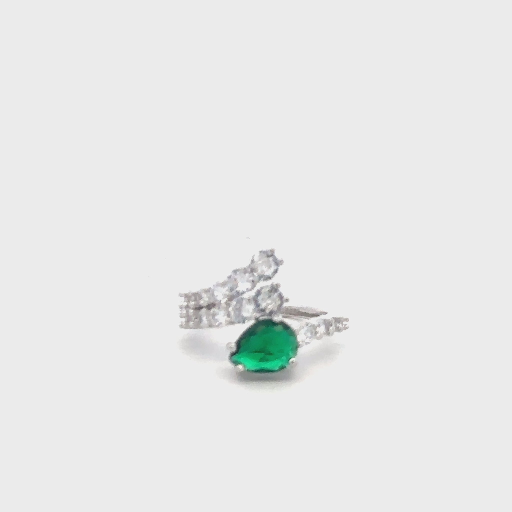 Elegant green gemstone ring in sterling silver with sparkling zircon details.
