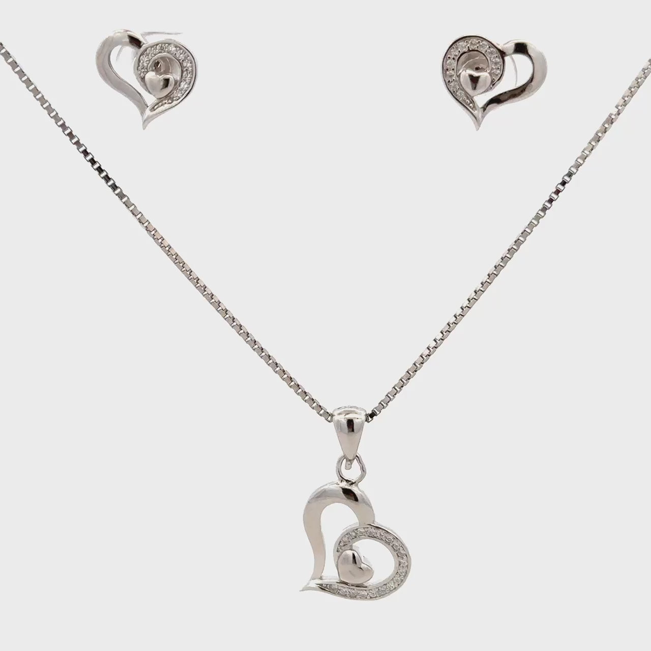 “Heart shape silver pendant set with matching earrings”